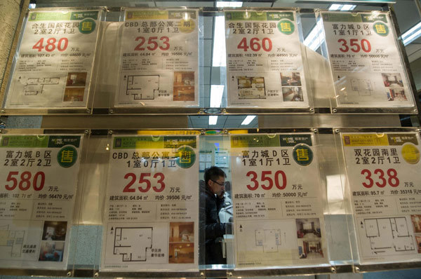 Advertisements of houses for sale posted at a real estate intermediate company, in Beijing, March 30, 2013. Beijing, Shanghai announce property regulation details
