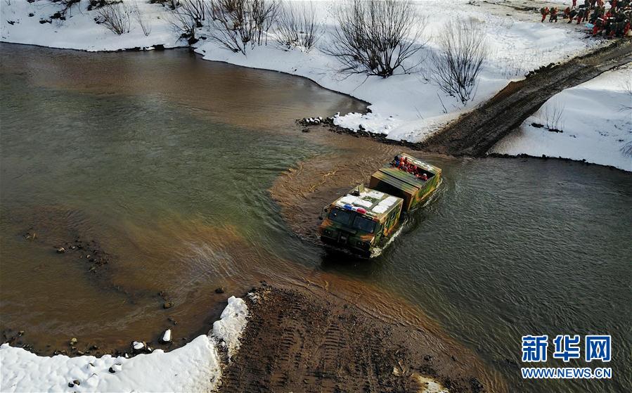 Firefighters withdraw from snow-covered forest