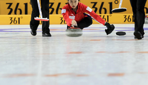 China's second Yue Qinghuang delivers a stone during their World Women's Curling Championship qualification round match against Sweden in Riga, March 19, 2013. China claims second victory in curling world cup