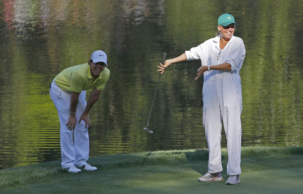 Rory McIlroy of Northern Ireland jokes with his girlfriend, tennis player Caroline Wozniacki of Denmark as she putts on the ninth hole during the annual Masters Par 3 Contest at the Augusta National Golf Club in Augusta, Georgia, April 10, 2013. Maturing McIlroy calls talk of rivalry with Woods premature