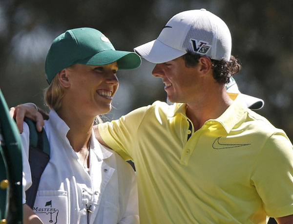 Rory McIlroy of Northern Ireland (R) and his girlfriend, tennis player Caroline Wozniacki of Denmark, stand on the first tee during the annual Masters Par 3 Contest at the Augusta National Golf Club in Augusta, Georgia, April 10, 2013. Maturing McIlroy calls talk of rivalry with Woods premature