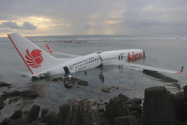 A Lion Air plane is seen in the water after it missed the runway in Denpasar, Bali, in this picture provided by the Indonesian police, April 13, 2013. All safe as plane misses Bali runway, lands in sea