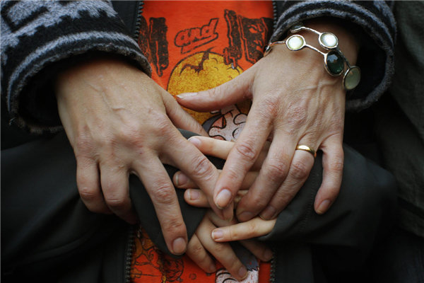 A mother holds the hands of her son as they attend an interfaith worship service at a memorial on Boylston Street for the victims of the Boston Marathon bombings in Boston, Massachusetts, April 21, 2013. Boston bombing suspects planned more attacks
